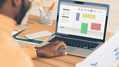 person creating schedule on computer