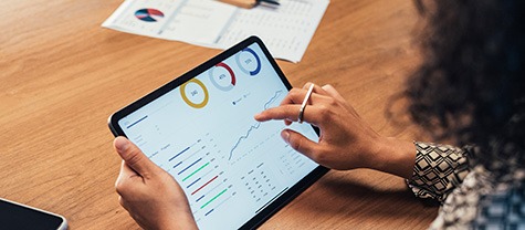 woman viewing statistic on tablet