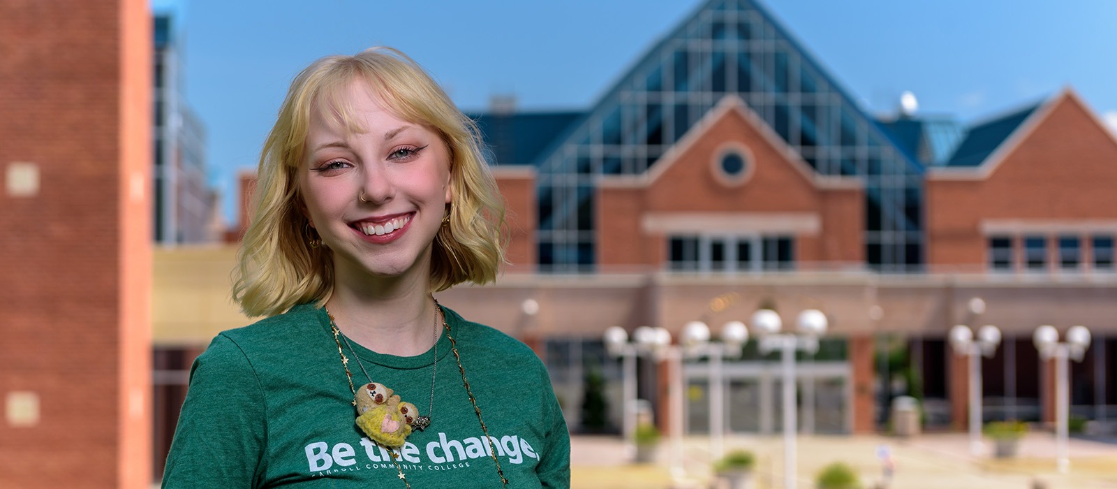 Carroll student standing in front of campus